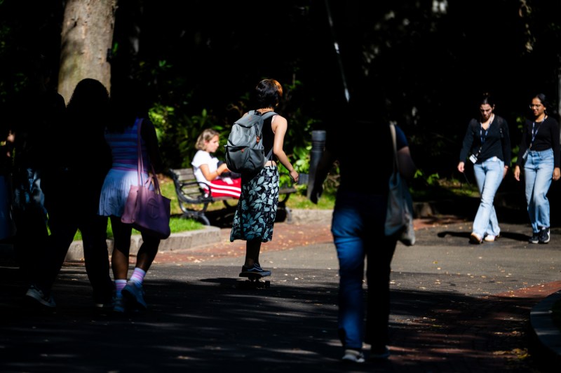 Members of the Northeastern community walk across campus.