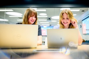 Casey Laguna and Elizabeth-Anne Burgett, both members of the Engineers Without Borders Club, work on a project in the ISEC building.
