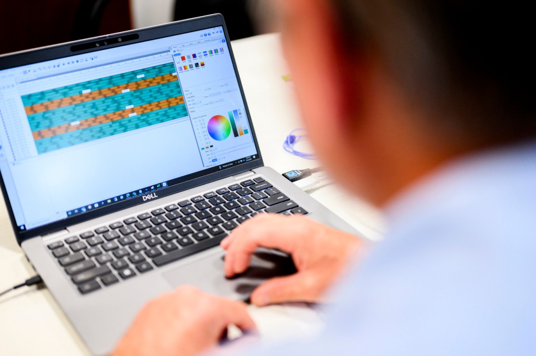 Joe Ranahan works on a Dell computer to create a software for displaying lights. 