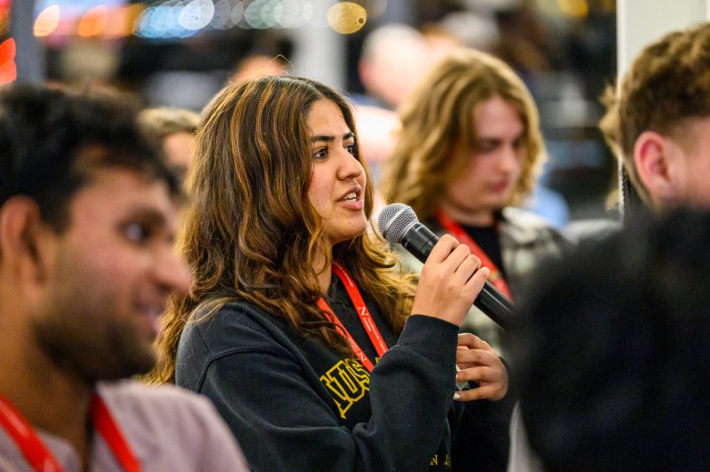 A student speaks into a microphone.