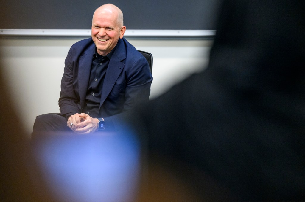 Michael Miebach, CEO of Mastercard, smiles while speaking with Northeastern students during a talk in Shillman Hall.