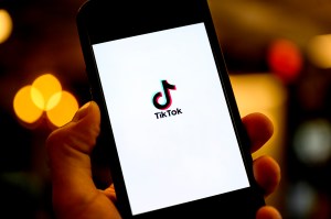 A smartphone screen depicting the TikTok logo against a white backdrop.