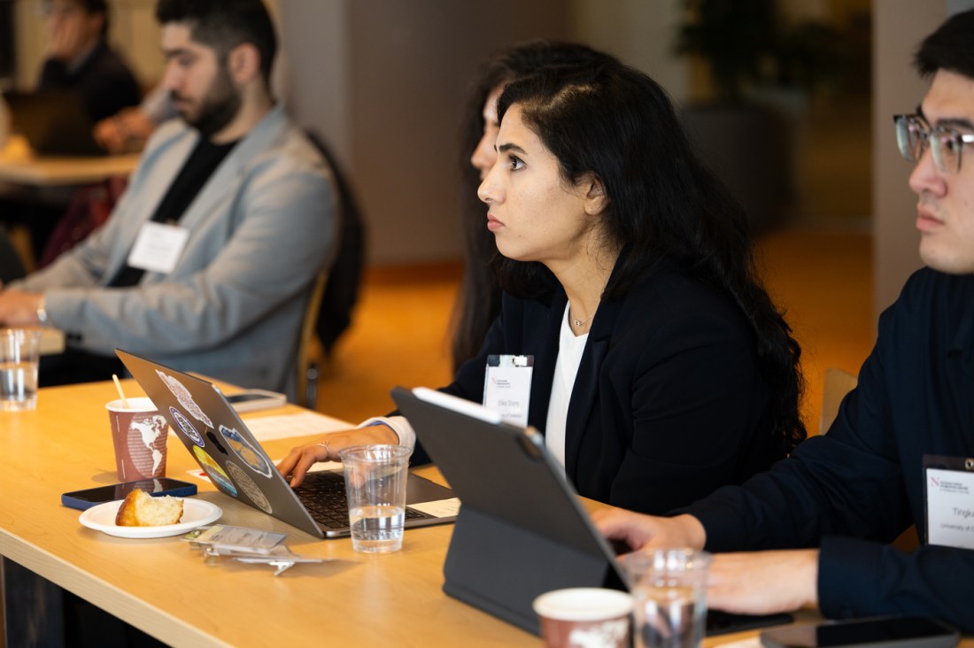 Audience members listen attentively during a panel discussion on AI leadership at Northeastern’s Alumni Center in Boston.