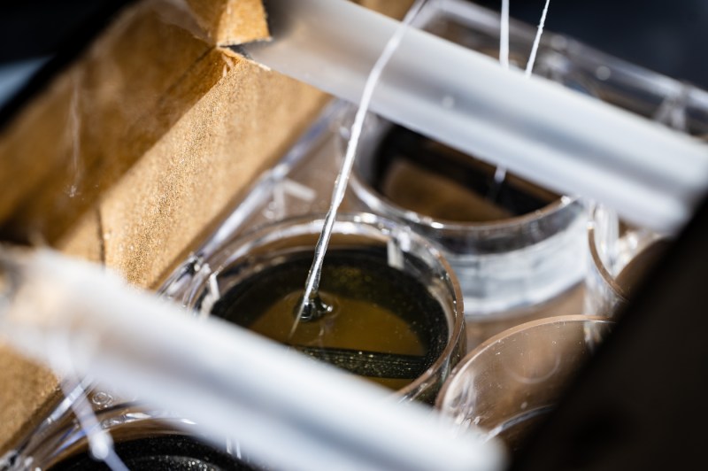 Laboratory setup showing tubing and circular containers used in a device experiment at Northeastern University’s BioInteractive Design Lab.