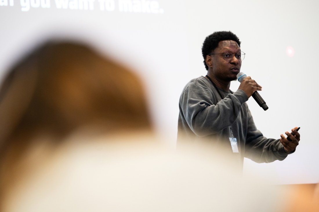 Joseph Ferguson speaks into a microphone during his keynote speech at the Social Media Summit. 