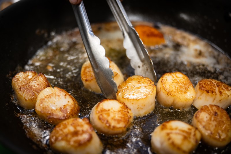Scallops are cooked on a pan.