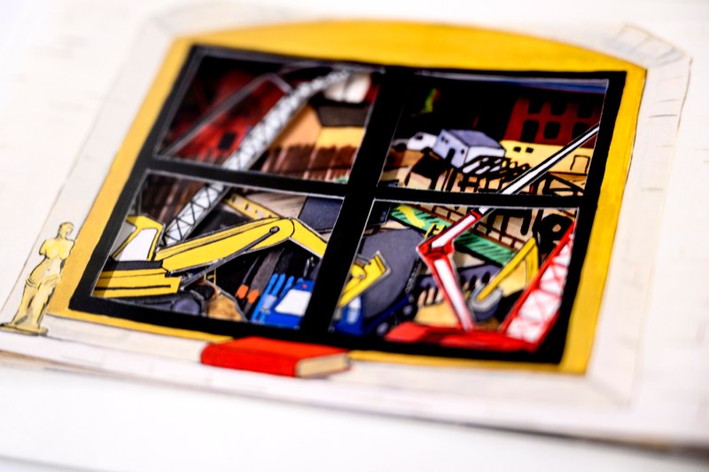 A close-up of a piece of art, which shows construction work, at Snell Library's special event.