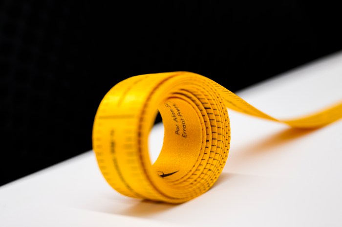 A yellow accordion-fold artist's book curls open on a table.
