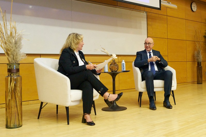 Northeastern University President Joseph E. Aoun sitting with Roberta Iannacito-Provenzano, provost of Toronto Metropolitan University, on a stage.