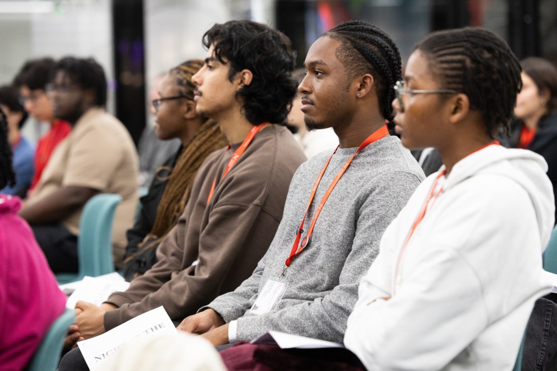 Audience members seated in rows, listening attentively during the “Night at the Museum” event at Northeastern University London.