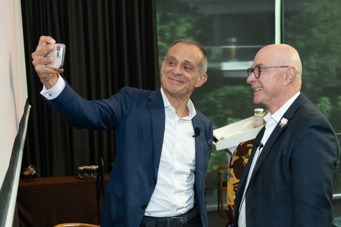 President Aoun smiles for a selfie with another person.