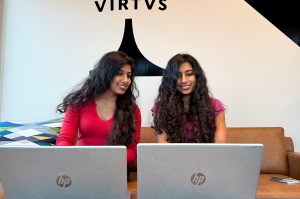 Reena and Reemaa Sajad Hyder, both graduate students, are on laptops, each in a red shirt.