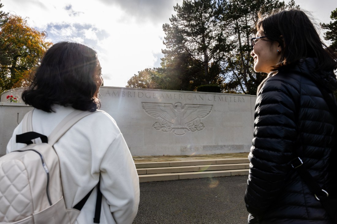 Two students stand in front of memorial at the Cambridge American Cemetary.