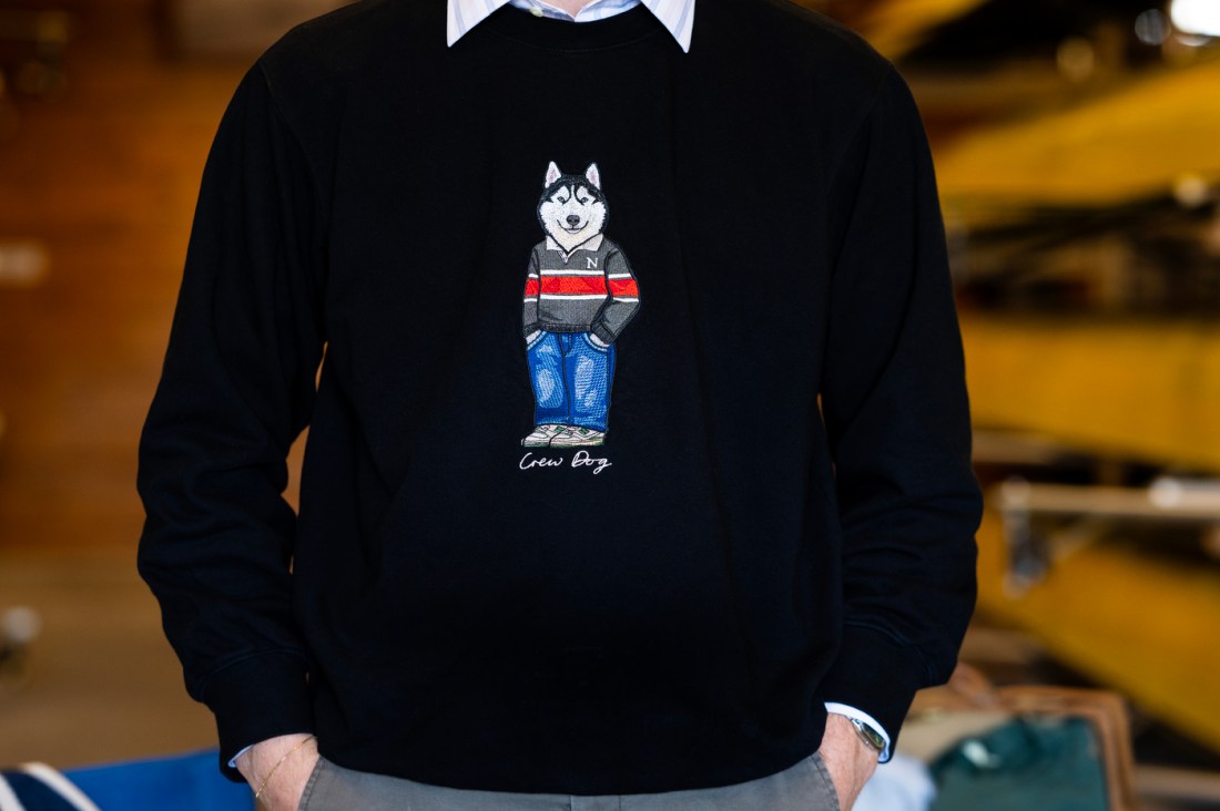 Northeastern student Nick Walding wears a Northeastern Crew Dogs sweatshirt featuring a husky.