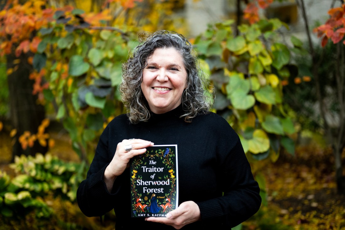 Author Amy Kaufman holds a copy of her novel, "The Traitor of Sherwood Forest."
