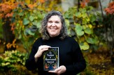 Author Amy Kaufman holds a copy of her novel, &quot;The Traitor of Sherwood Forest.&quot;