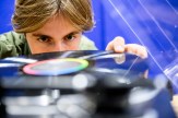 Patrick Dunn looking over a vinyl record.