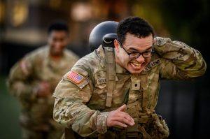 Christian Figueroa, a U.S. Army staff sergeant, straining in his Army uniform during a workout.