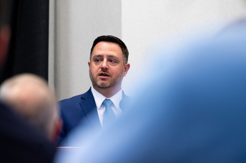 A man in a suit and tie speaks at the 2025 Veterans Day Ceremony. 