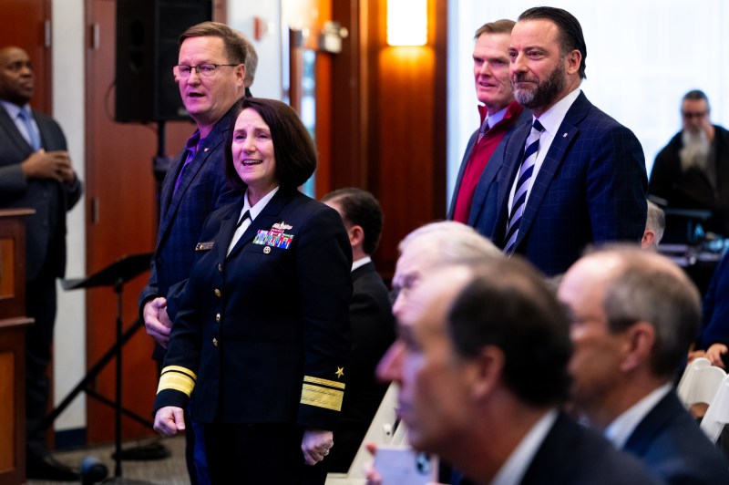 Rear Admiral Jennifer S. Couture and Jack Cline standing up next to two others at the 2025 Veterans Day Ceremony. 