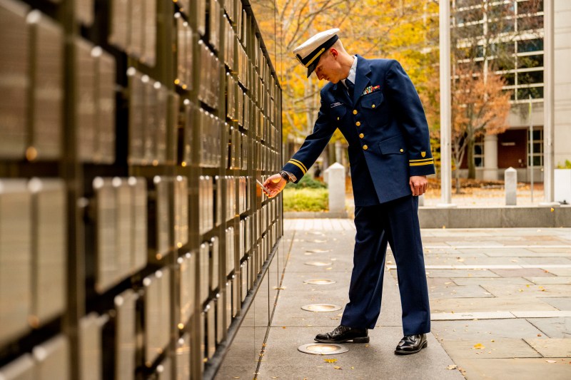 LTLG Jack Farrell looks at the name plaques on the Veterans Memorial on Northeastern's Boston campus. 