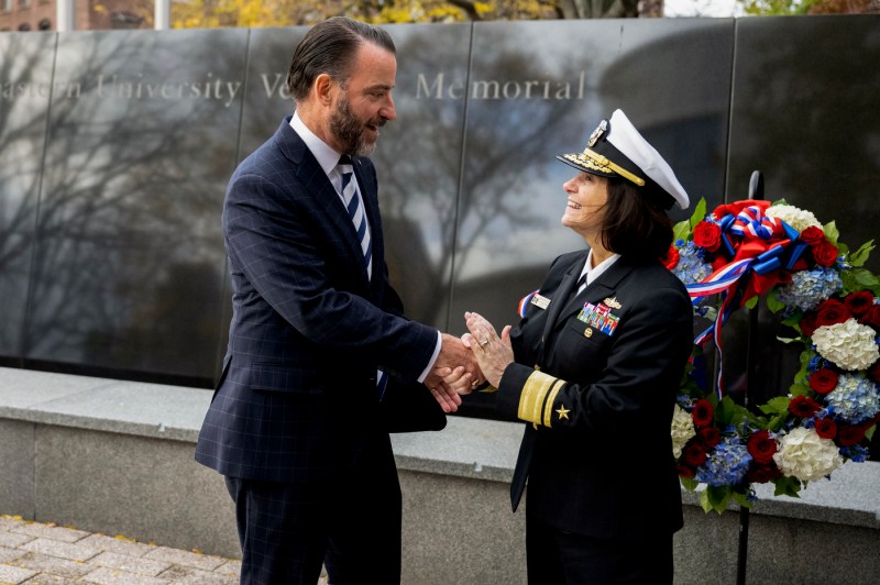 U.S. Navy Rear Admiral Jennifer S. Couture shakes hands with Jack Cline, who served in the U.S. Marine Corps and is vice president of federal relations for Northeastern.