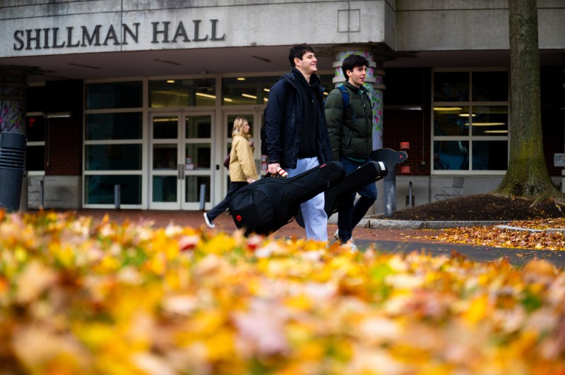 Two members of the Northeastern community walk past Shillman Hall.