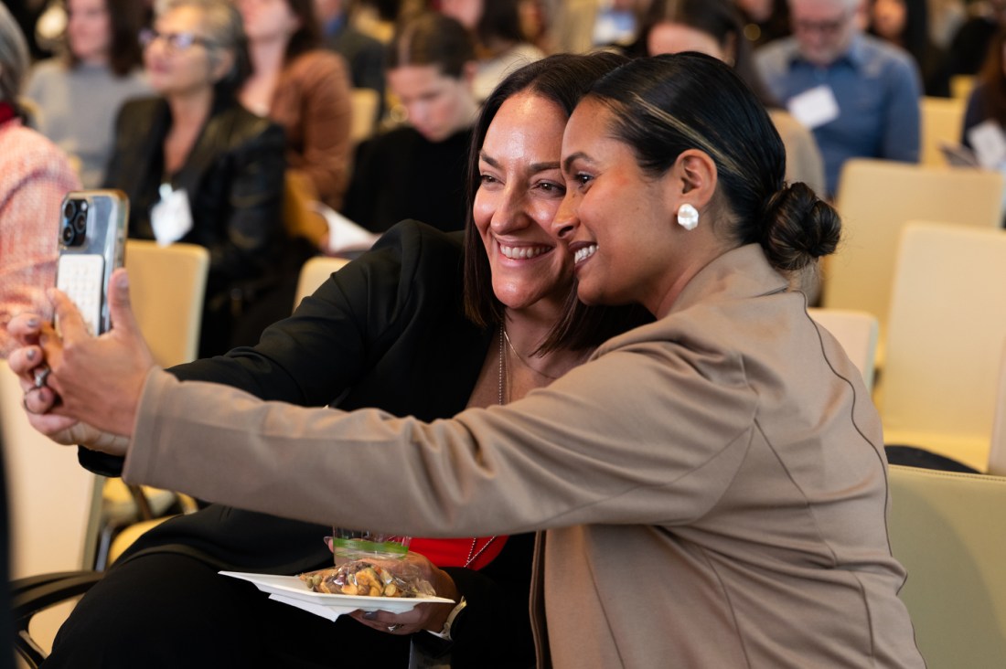 Two audience members take a selfie at the Women Who Empower summit.