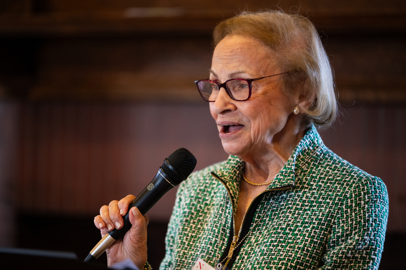 Corinne Reppucci speaks into the microphone during the luncheon event at the Endicott Estate.
