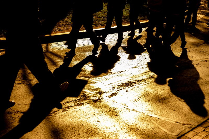 A showdy image of students legs walking through campus.