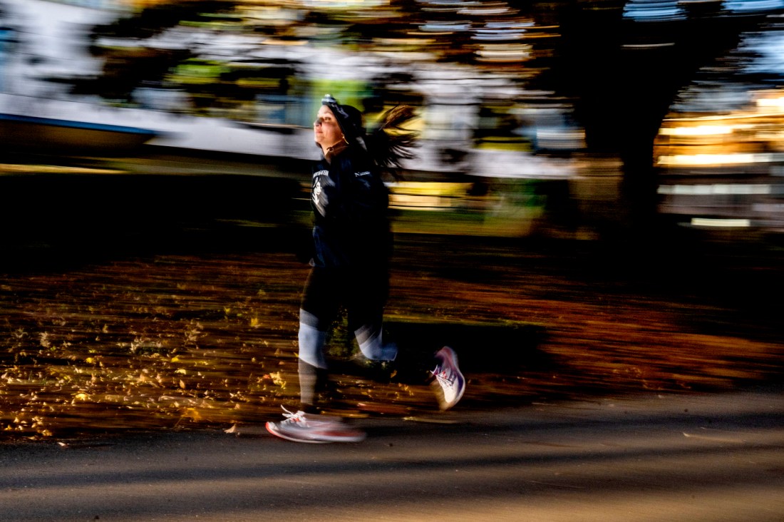 A time lapse photo of Michaela Quigley running at twilight.