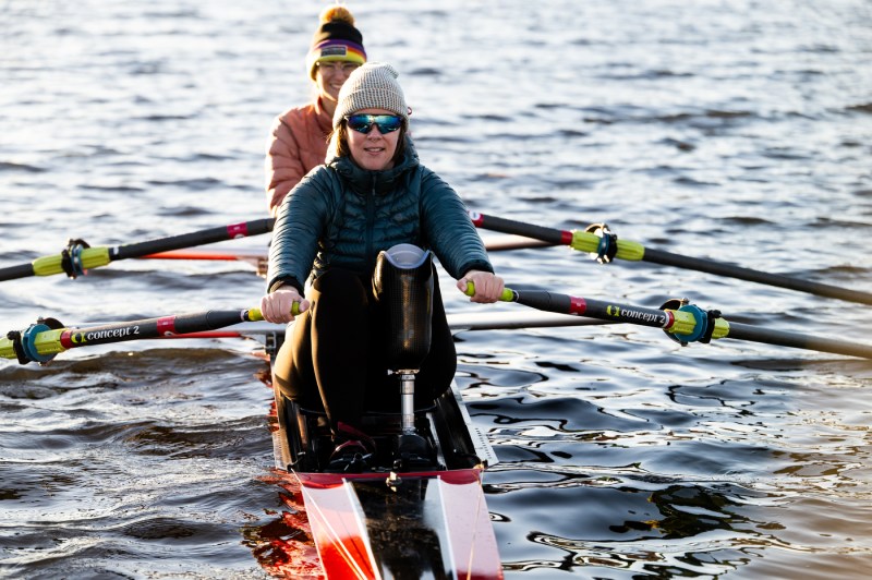A close-up of two people rowing in a double skull.