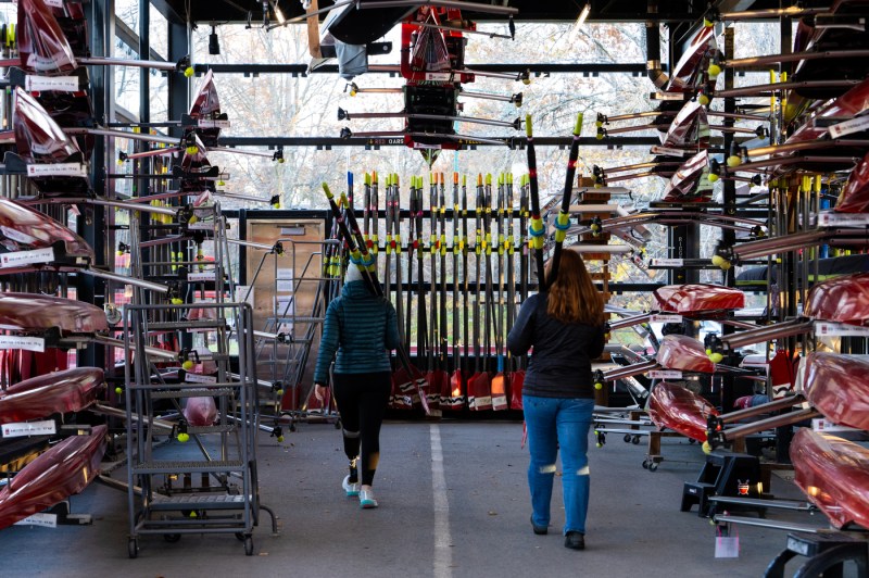 Megan Hopkins and Ella Hughes return oars to the CRI Rowing boathouse on Tuesday, Nov. 18, 2025. Northeastern students designed a prosthetic foot and ankle designed specifically for rowing that Megan Hopkins tested on the water for the first time. 