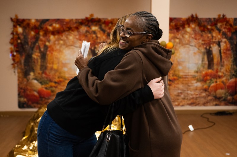 Two people hug in each other.