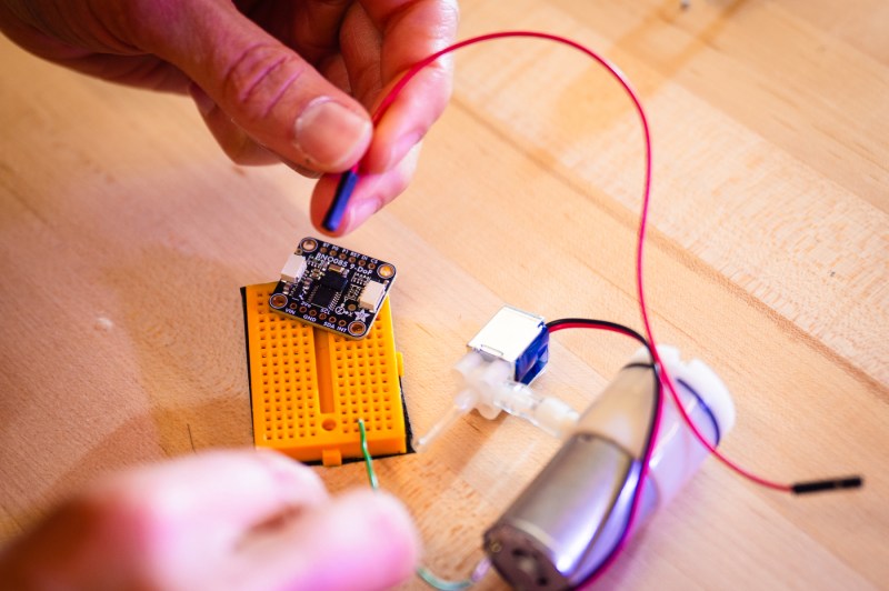A person does electrical work on an adaptive splint.