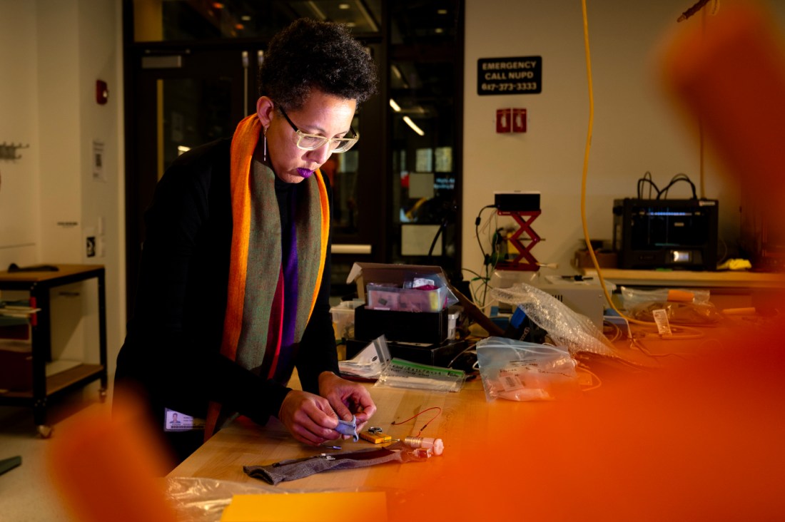 Kris Dorsey working on an adaptive sleeve in a lab environment.