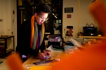 Kris Dorsey working on an adaptive sleeve in a lab environment.