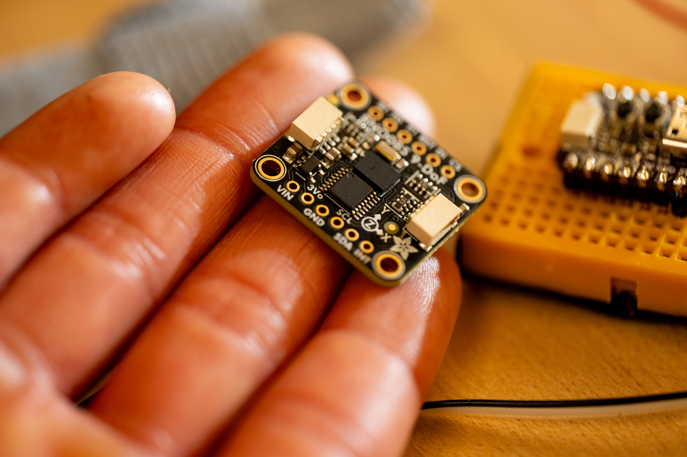 A small switchboard balanced on Kris Dorsey's fingers. 