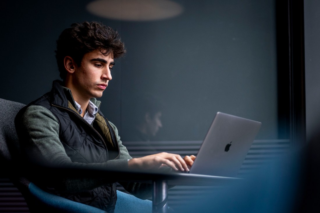 portrait of student with dark hair working at computer 