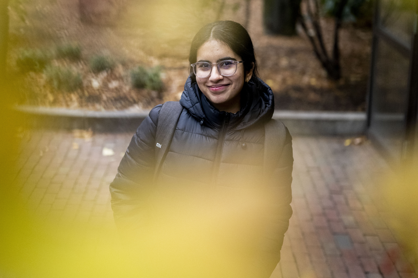 A person wearing a winter jacket poses for a photo outside.