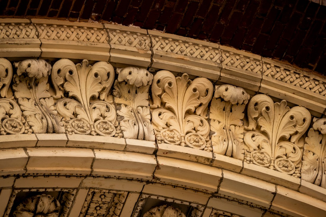 Close-up of ornate scrollwork along the Matthews Arena archway.
