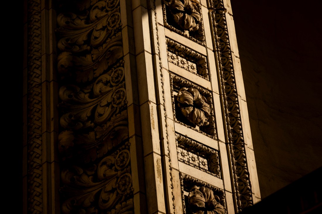 Detailed view of decorative molding and ornamental panels on Matthews Arena archway.