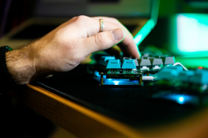 A close-up of a hand typing on a keyboard.