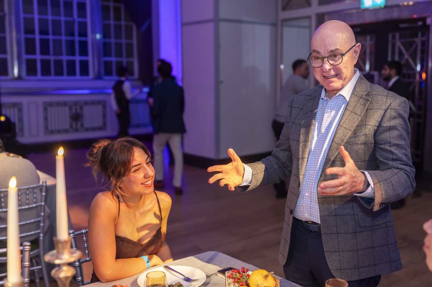 Northeastern University president Joseph Aoun wearing a checkered shirt and suit as he speaks to college students