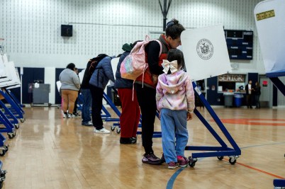 Voters in New York fill out ballots inside a gymnasium.