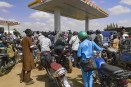 People queue with their motorcycles at a gas station amid a fuel shortage in Bamako Mali.