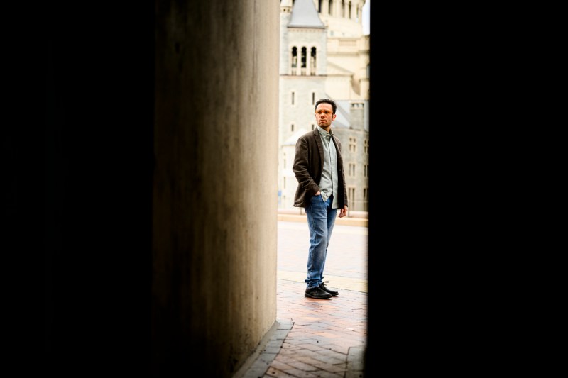 Iacopo Iacopini stands at the end of a narrow passageway. 