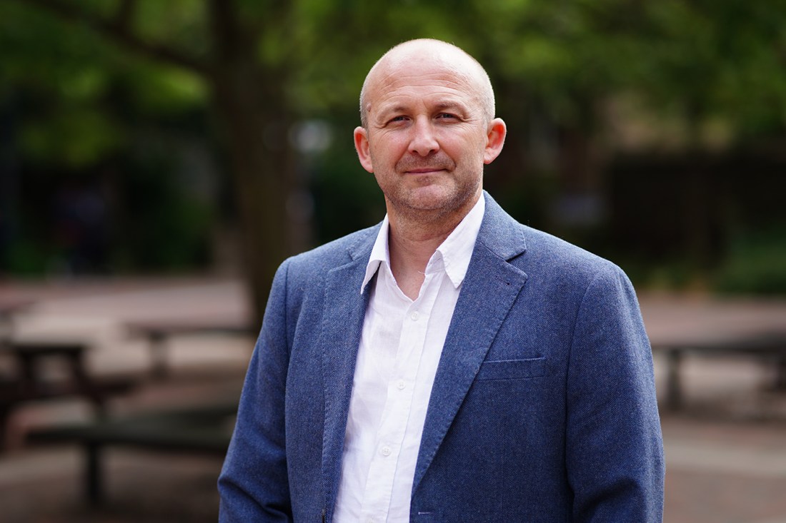 Researcher Istvan Kiss wearing a white shirt and blue blazer