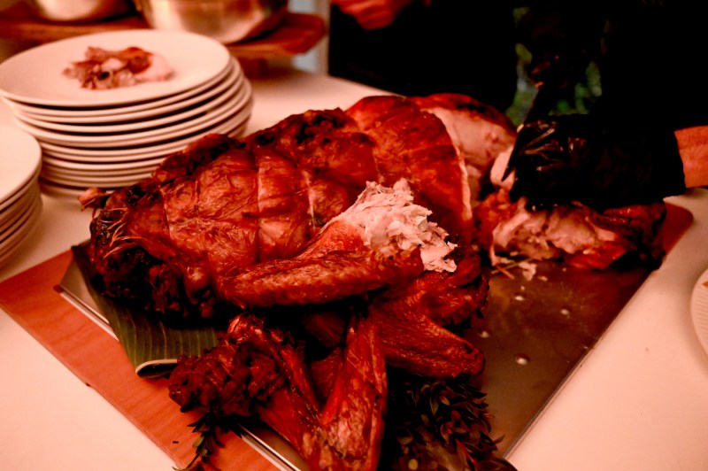 A close-up of a Thanksgiving ham, ready to be served on a table.