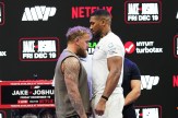 Jake Paul, left, and Anthony Joshua, right, face off during a news conference.